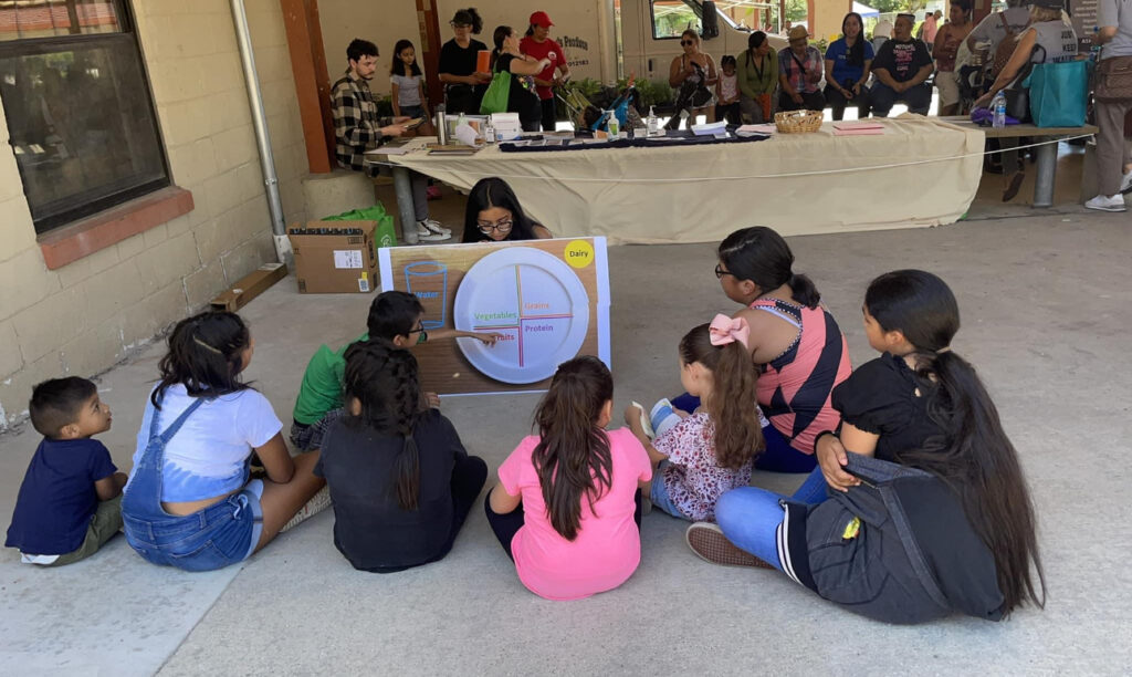 Priya sitting with the children